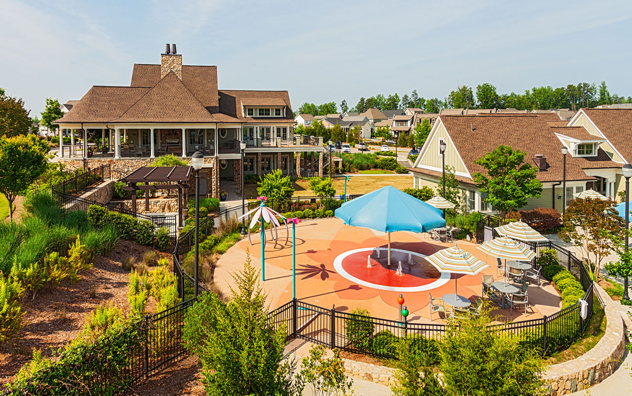 Splash pad with club house in background at Briar Chapel community
