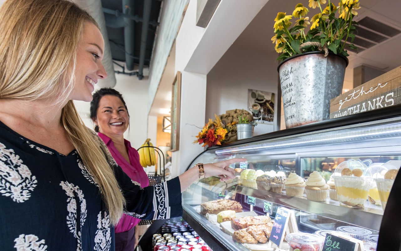 Two women browsing for pastries