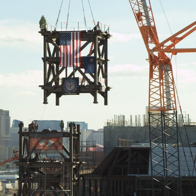 Construction of Symphony Park with American flag hanging from crane