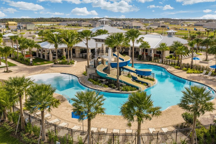 Picture of the Waterset Club community and resident-only clubhouse, fitness center, and resort-style pool in Tampa Bay next to their basketball, pickleball, tennis, and sand volleyball courts.