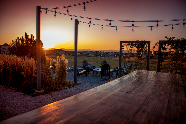 Sunset at outdoor recreation park with table, fire pit and chairs at Inspiration Colorado